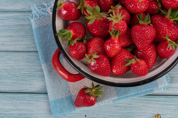 Strawberries in an old red enamelled dish