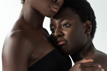 cropped view of african american women in tops isolated on grey