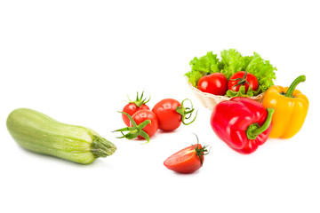 Ripe fresh organic vegetables in drops of dew isolated on a white background. Tomatoes, zucchini, bell peppers and lettuce isolated on a white background.