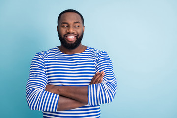 Portrait of cheerful afro american guy job sailor worker cross hands look copyspace listen to his friends colleagues wear trendy nautical vest frock isolated over blue color background