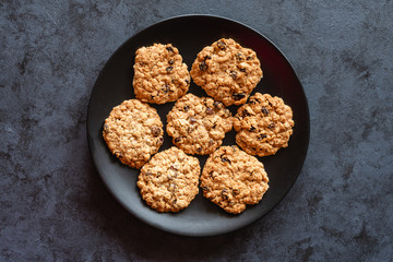 Homemade oatmeal cookies with raisins on a dark background