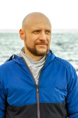 Portrait of a bald man on the sea coast