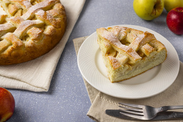 Apple pie on gray table background. Homemade classical fruit tart.