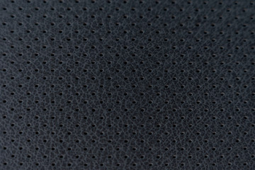 black perforated leather, background image, selective focus, tinted image