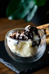 chocolate ice cream with nuts in a glass bowl
