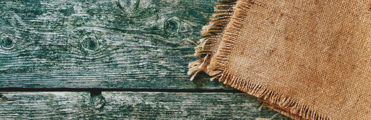 Background and texture of old boards and jute. Panorama.