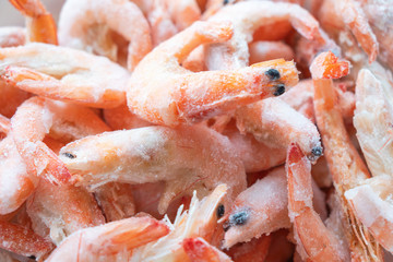 Frozen big shrimps close up. Raw frozen shrimp background. Pile of frozen shrimps background