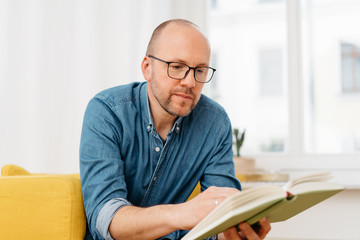 Middle-aged man wearing reading glasses