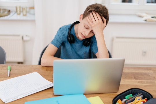 Young boy having problems with his e-learning