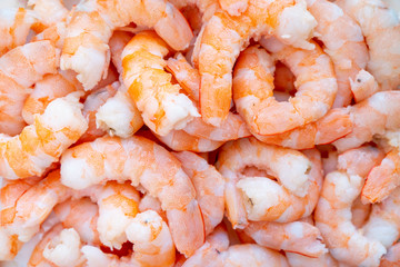 Peeled fresh shrimp background. Big shrimps close up. Raw fresh shrimp background. Pile of fresh peeled shrimps background