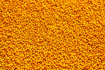 Yellow polymer dye in granules, background texture