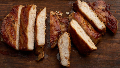 fried pork steak sliced on stripes on a kitchen cutting board