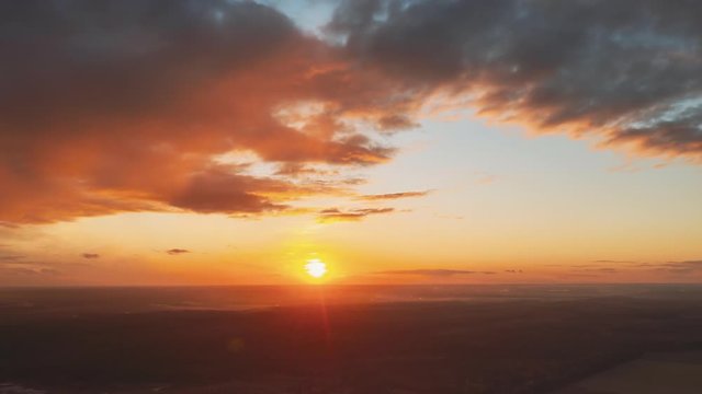 Aerial View Of Sunshine Bright Dramatic Sky. Scenic Colorful Sky At Dawn. Sunset Sky Above Autumn Field And Meadow, Forest Landscape In Evening. Top View From High Attitude. Hyperlapse