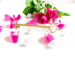 Pink, white, green, gold Bible flat lay with pink roses, petals and pearls, colorful Bible. Bright and white background