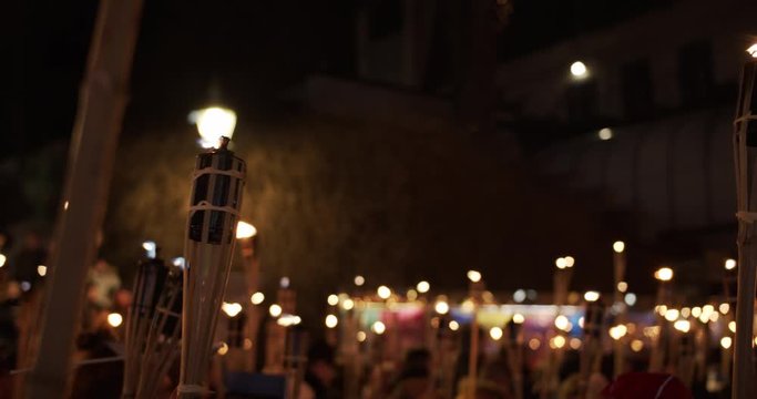 Torchlight procession march at night people protest with burning torches