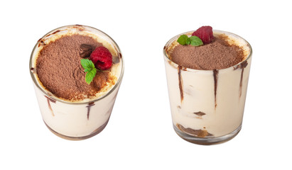 tiramisu in a glass with berries, mint and coffee beans on a light wooden background