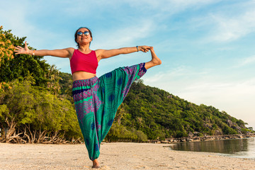 Asian Thai woman practicing yoga in Haad Seekantang beach, Koh Phangan island, Thailand