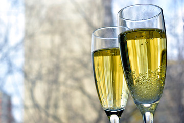 Two glasses of champagne on the background of a bokeh street
