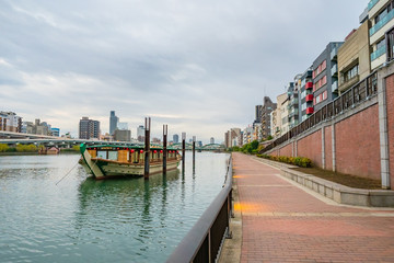 Fototapeta premium Japan. Tokyo in autumn day. Dock on the island of Odaibo. Japanese-style ferry is parked near the shore. Embankment View of Tokyo from the island of Odaibo. Travel to Japan. Regions of Japan