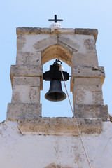 White Church Bell tower of the Orthodox Christian chapel with cross against sky