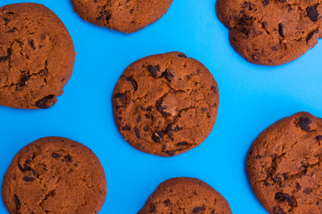 Chocolate cookies on a blue background. Background of homemade chocolate chip cookies.