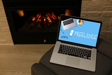 Home freelance desktop with open laptop computer on the table, blank screen for information content or text message