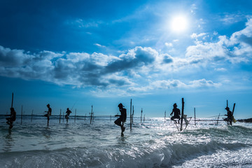 Traditional stilt fisherman at sunset in Sri Lanka