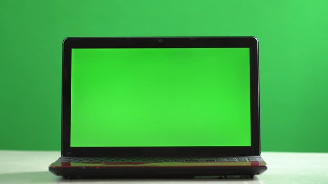 Closeup woman sitting table notebook female hands keyboarding laptop using texting pointing networking green screen chroma key chromakey keyboard white device working message student businesswoman