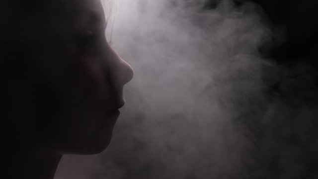 Kid in a mist or fog breathing with eyes down