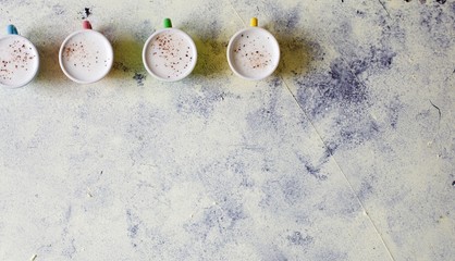 Cute baby cappuccinos or babyccino macchiato flat lay image with copy space