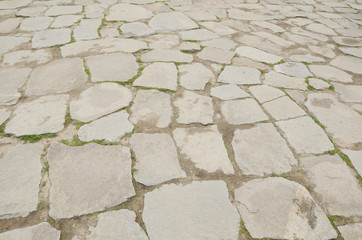 An uneven stone mosaic tile at old town of Seoul.
