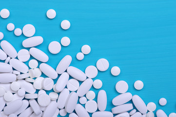 Heap of pills on blue