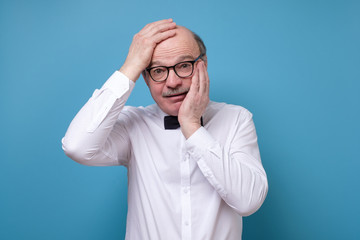 man looking at caemra puzzled and thinking having no idea what to do