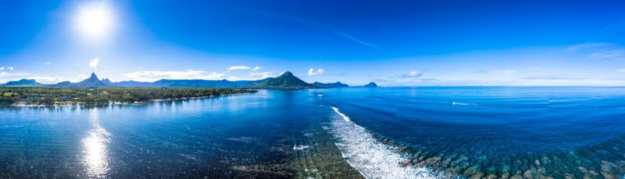The beach at Flic en Flac with luxury hotels and palm trees, behind the mountain Tourelle du Tamarin, Mauritius, Africa
