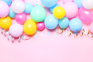 Pink birthday background with balloons, confetti and streamers, top view