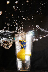 Lemon dropped in a glass of water