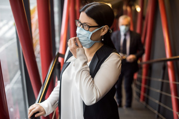 asian businesswoman in formal wear with medical mask looking away