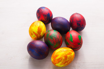 Holidays, traditions and Easter concept - Multi-colored decorative colourful eggs on white background. Top view.