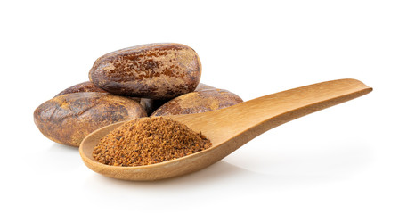 Nutmeg powder in wood spoon on white background