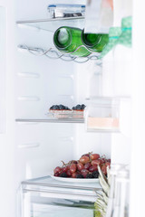 Open fridge full of fresh fruits and vegetables