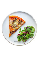 slice pizza and salad leaves in a plate on the table (tasty snack) menu concept background. top view. copy space for text