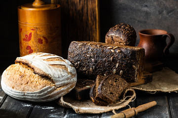 Assortment of baked goods on wood background. Rye bread. Wheat bread. Vegeterain food concept....