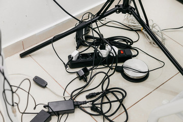 tangled wires of sockets on the floor in the office