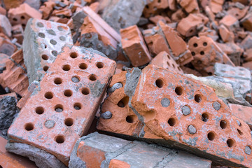 Old and broken bricks dumped in a pile after the demolition of a building