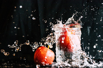 Fototapeta na wymiar Apple dropped in a jar of in water