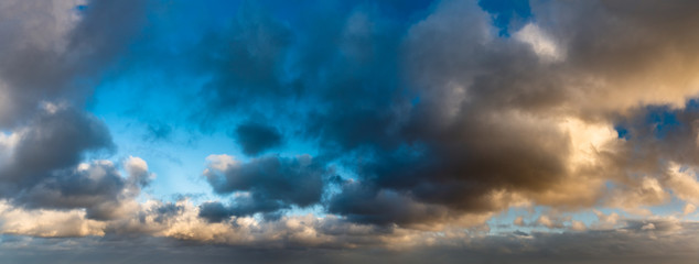 Fototapeta premium Fantastic dark blue thunderclouds at sunrise, natural composition