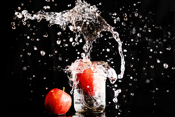 Fototapeta na wymiar Apple dropped in a jar of water