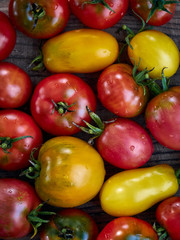 Fresh ripe tomatoes on wooden background.