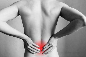 Injuries to the spine and lower back, fatigue at work. Area of the injury, the image on a clean...
