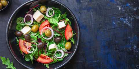 healthy salad olives, lettuce, tomato and cheese feta (greek salad, tasty vegetables snack) menu concept background. top view. copy space for text